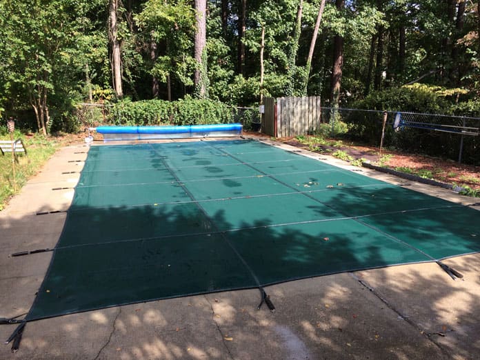 A custom safety cover installed on a pool in Garner