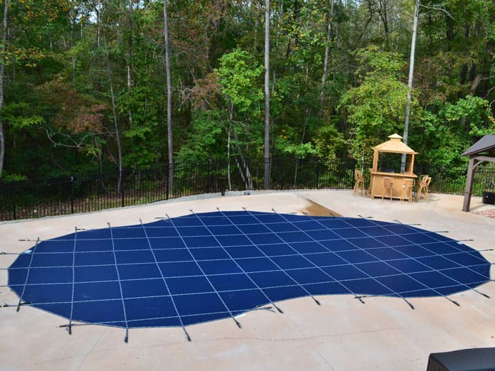 A custom safety cover installed on a pool in Raleigh