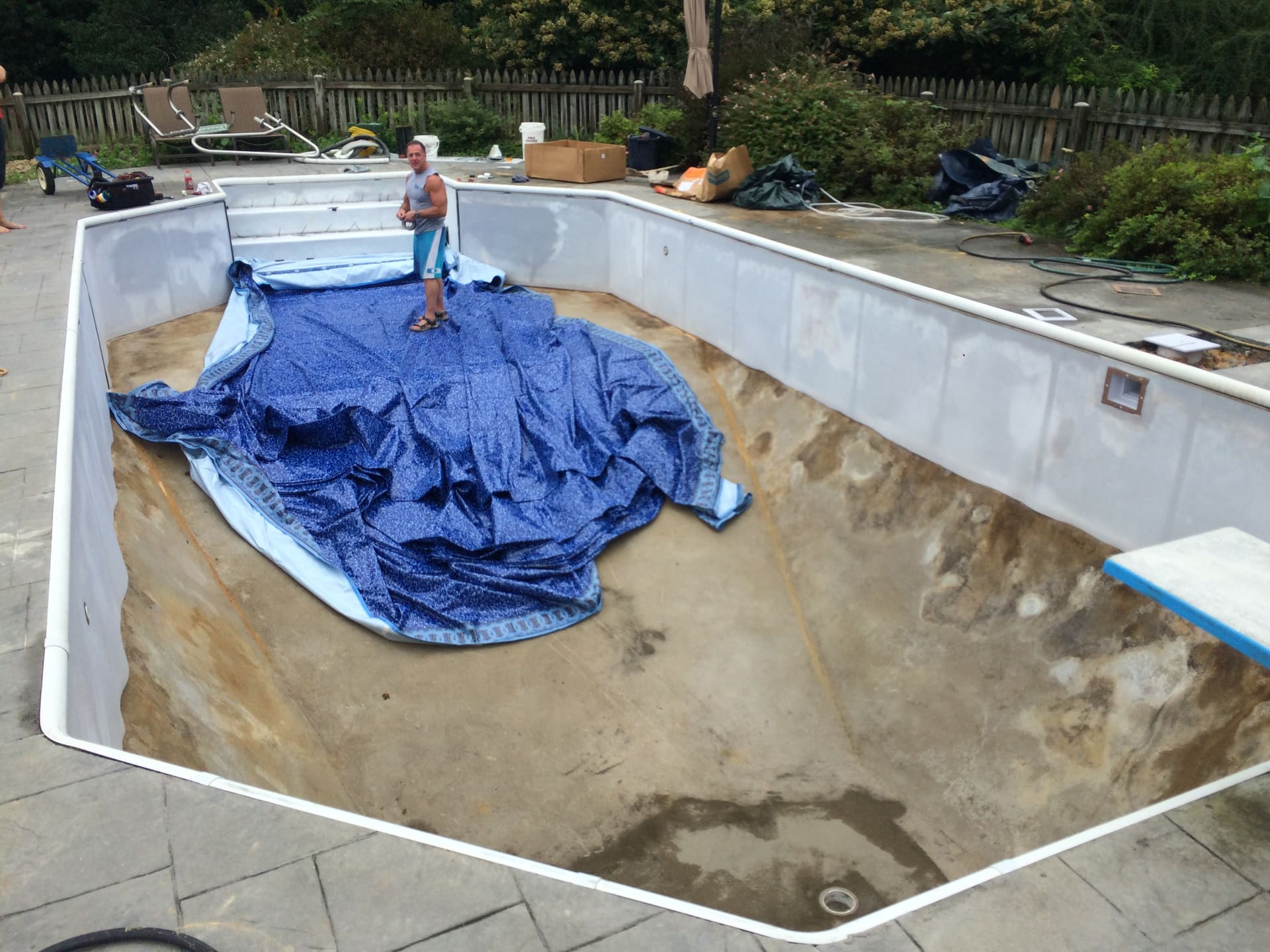 A drained pool with its old liner removed, ready for a new one